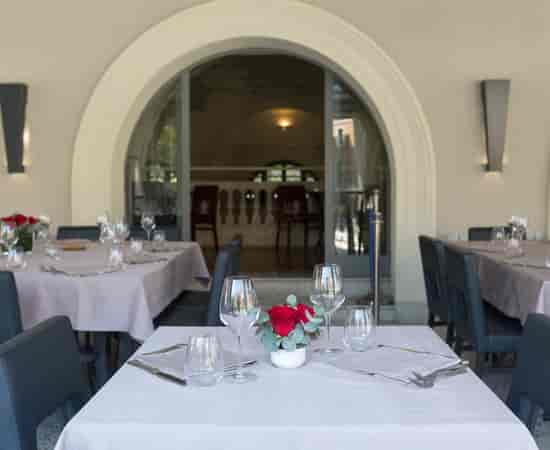 Gourmand's Restaurant: elegant table settings for corporate dinners and VIP events.