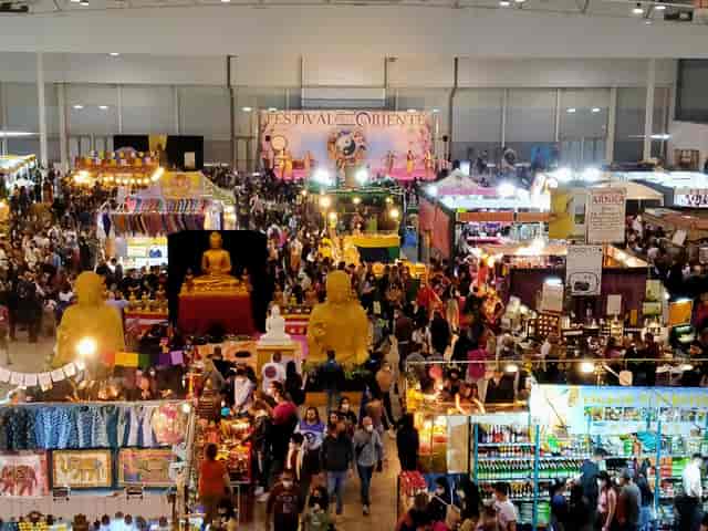 Fiera Roma exhibition center with crowded vendor kiosks and stage for consumer trade show events.