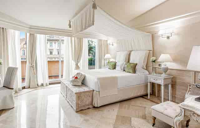 Luxury hotel suite at Villa Duse with elegant canopy bed for VIP accommodations and bridal events.