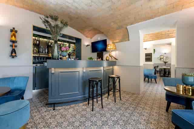 Blue bar in Rome lounge with vaulted brick ceilings for VIP events and networking receptions.