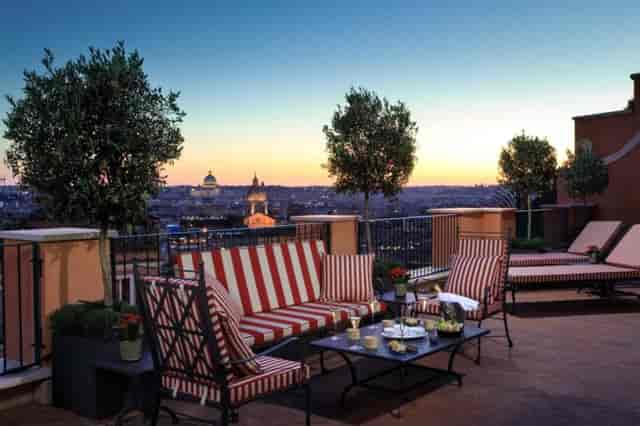 VIP welcome reception at La Ville Rome bar with skyline view and lounge seating.