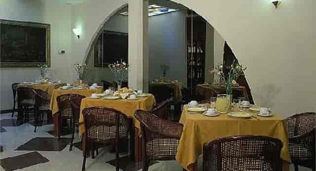 Intimate hotel restaurant with rattan seating, ideal for executive luncheons and breakout sessions.