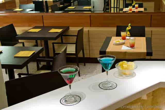 Casual networking reception setup with high-top tables at Hotel Memphis restaurant.