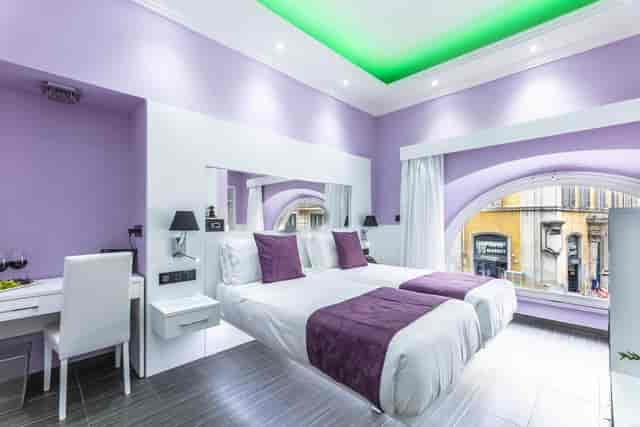 Deluxe twin room at THE ONE Boutique Hotel with ergonomic workspace for incentive travel events.