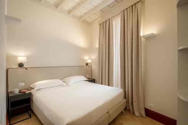Boutique hotel room for VIP accommodations, neutral decor, ideal for conference event lodging.