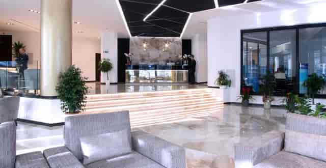 Contemporary hotel lobby with tiered lighting for VIP event registration and networking.