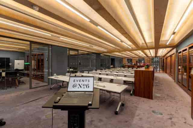 Modern library meeting room with tables, ideal for events and presentations.