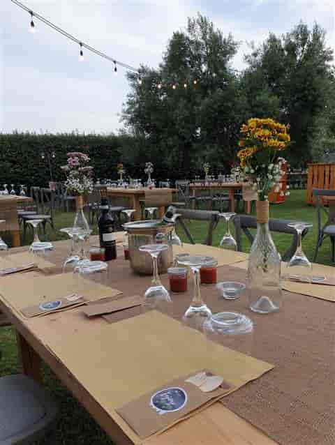 Rustic-chic outdoor garden event setup with wooden tables at Rome Marriott Park Hotel.