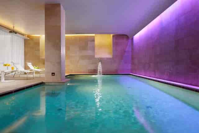 Infinity Meeting Room indoor pool at Palazzo Montemartini for luxury wellness retreats and events.