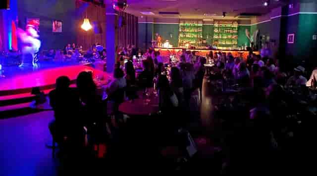 Live Dinner Club venue with cabaret seating for corporate events and evening entertainment.