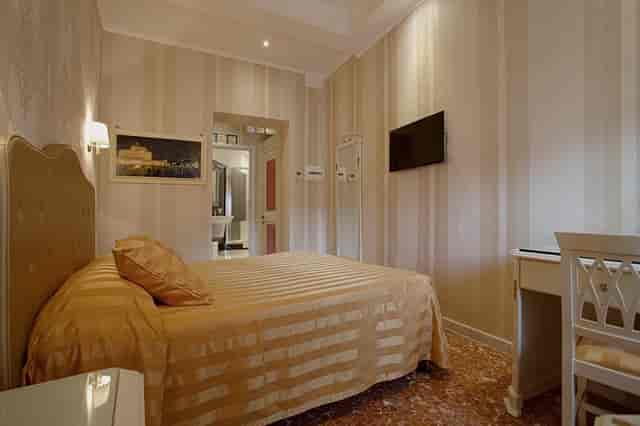 Compact budget hotel room at Suites in Navona Queen Rome for corporate travel and group events.