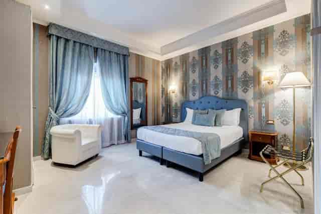 Upscale hotel room at Navona Queen Rome, elegant traditional suite for VIP luxury group bookings.