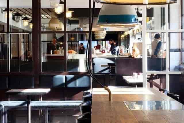 Industrial-chic Portofluviale restaurant venue with modular seating for networking and breakouts.