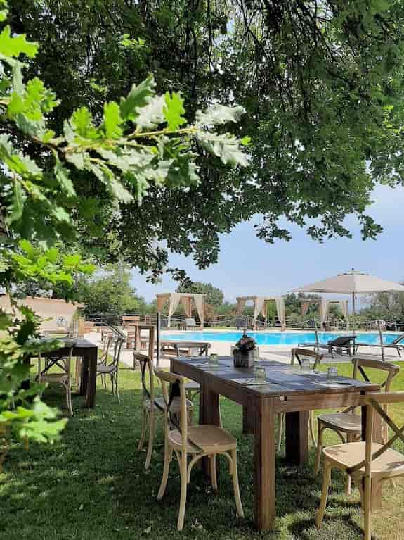 Borgo Pallavicini Mori dining area with poolside lounge for corporate retreats and social events.