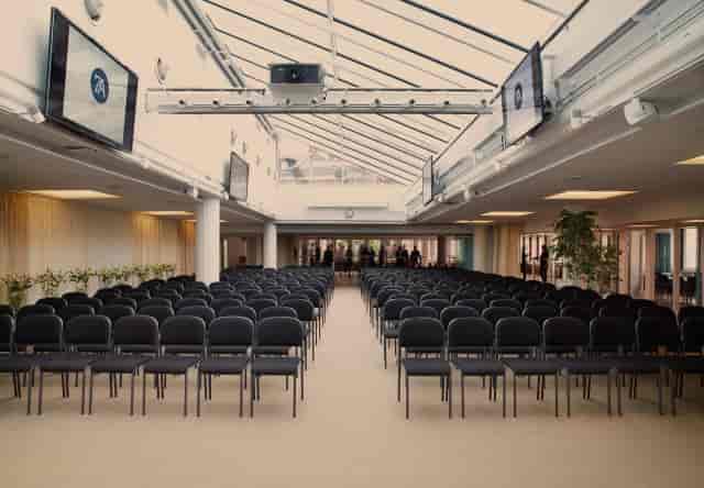 Modern coworking space with theater seating for corporate presentations and business events.
