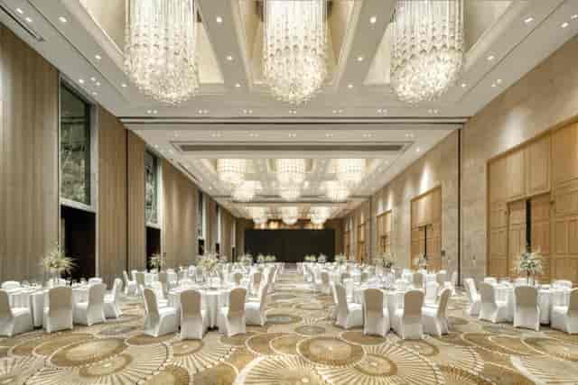 Luxury ballroom at Crowne Plaza with crystal chandeliers for weddings and corporate summits.
