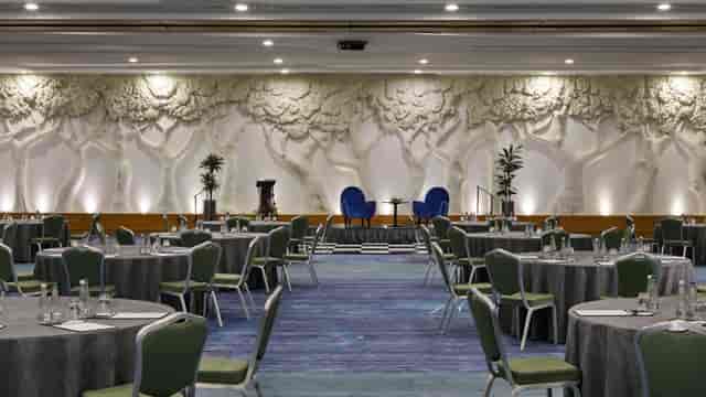 Crowne Plaza ballroom with 3D woodland wall for corporate panel discussion and event hosting.
