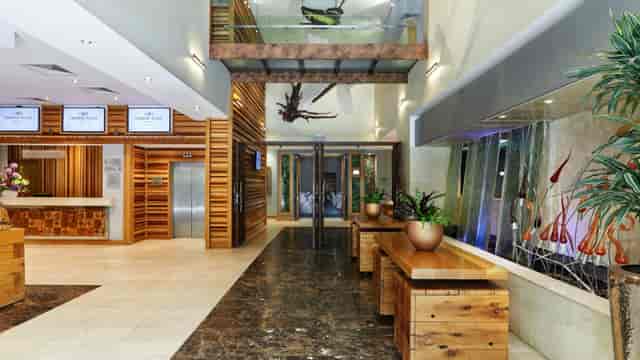 Modern hotel conference center foyer with check-in desk for event registration and delegate flow.