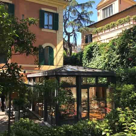 Glass pavilion in Villa San Pio garden for sophisticated wedding or corporate event reception.