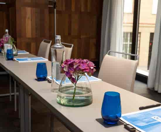 Upscale boardroom with floral centerpiece for corporate meetings and executive events.