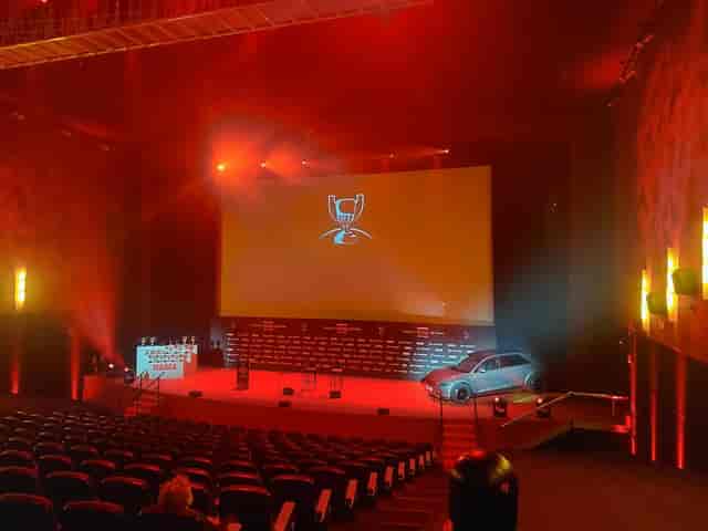 Product reveal at Espacio Burdeos Teatro Goya with red stage lighting for car launch event.