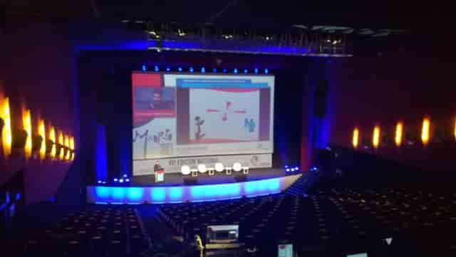 Sala Goya at Teatro Goya: Blue-lit tiered theater plenary setup for corporate events.