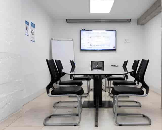 Boardroom with glass table for small project meetings and professional corporate events.