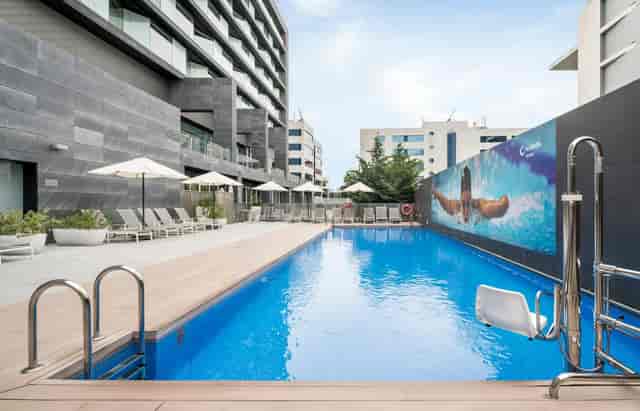 Modern hotel pool deck at ILUNION Atrium for corporate events and networking receptions.