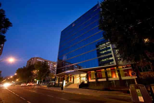 Lucayanes Crowne Plaza Madrid venue exterior at twilight for corporate events.