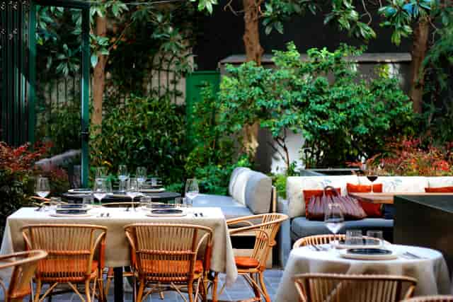 Lush outdoor terrace at Restaurante Tragaluz Madrid for corporate reception and client dinner.