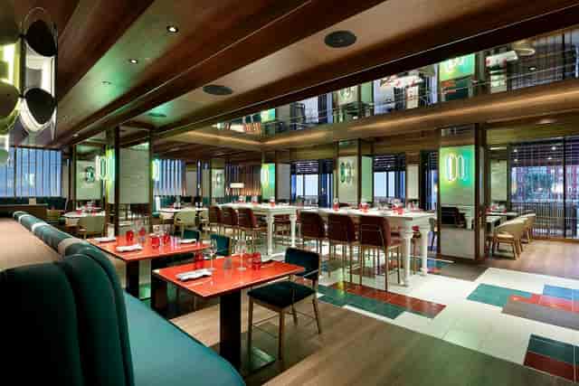 Roxy Lounge event space with communal tables for corporate networking and breakout sessions.