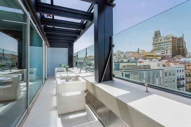 Modern rooftop terrace at Room Mate Óscar for corporate retreats and networking events.