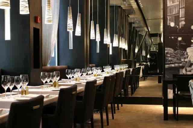 Upscale hotel dining area with elegant table settings for corporate dinners and board events.