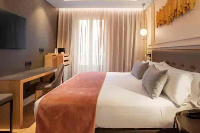 Upscale Hotel Catalonia Goya suite with workspace for business travel and conferences.