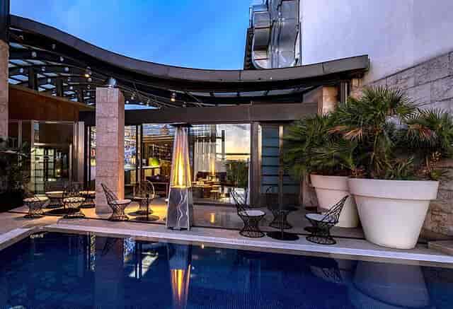 Rooftop lounge at Hotel Urban with pool and fire heaters for VIP events and cocktail receptions.