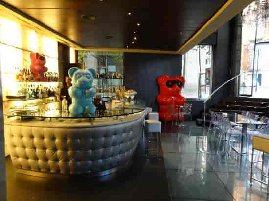 Modern Glass Bar at Hotel Urban featuring bold pop-art decor for networking events and VIP lounges.