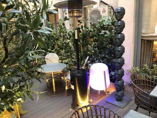 Eclectic sculpture at Club Monteverdi networking event, outdoor exhibition space with mood lighting.