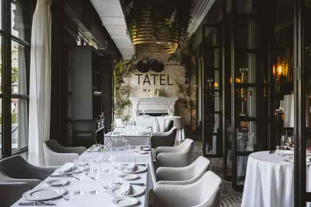 Tatel restaurant bar with white-linen decor for upscale corporate events and private dining.