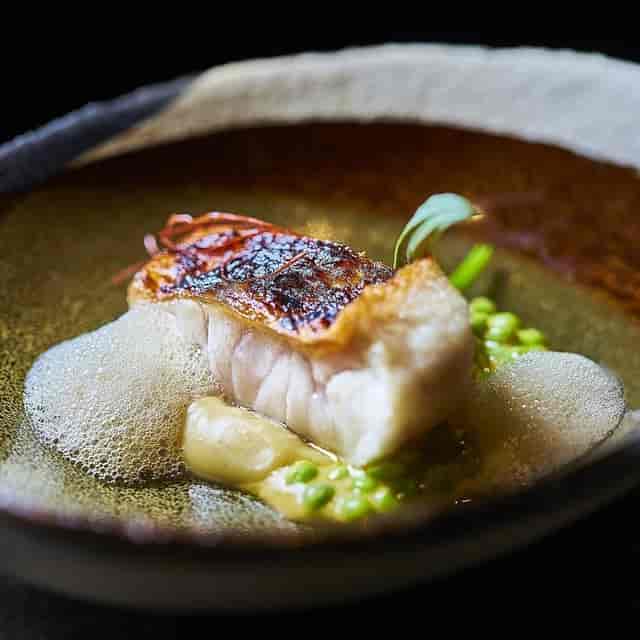 Refined plated main course at Smoked Room Madrid for executive board dinners and VIP galas.