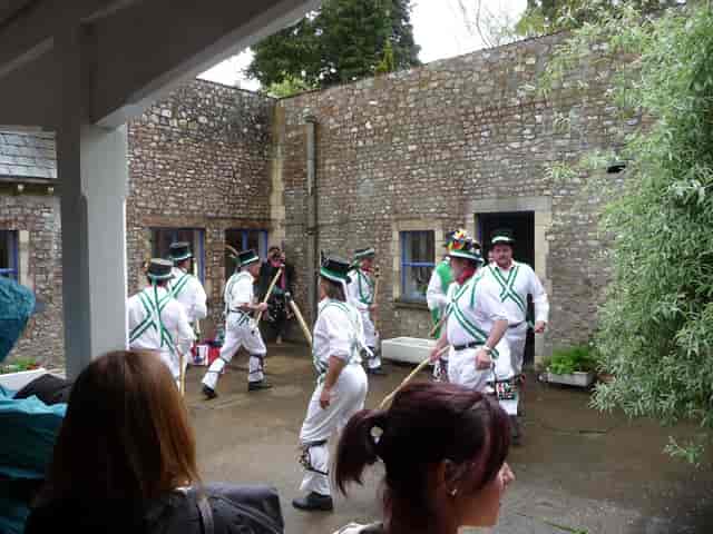Folk performance in Monkton Wyld Court Pine Hall for corporate retreat off-site meeting.