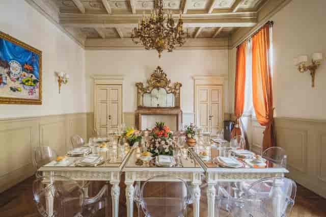Luxury boardroom with mirrored tables and ghost chairs for executive meetings and corporate dinners.