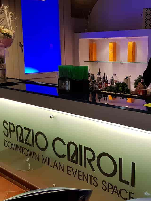 Sleek branded pop-up bar with under-lit counter for corporate events and professional networking.