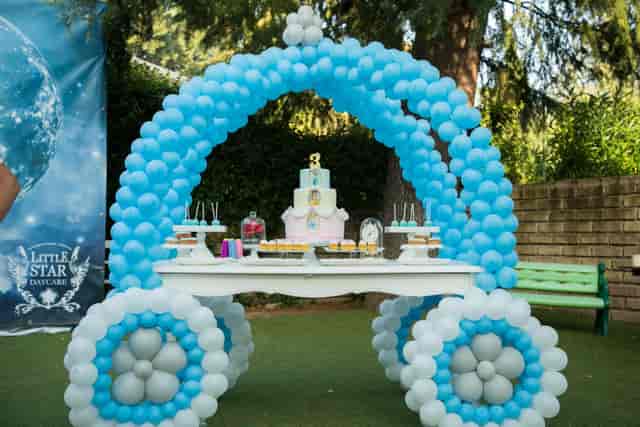 Baby shower dessert station with whimsical balloon carriage at Luna Di Vanna outdoor event.