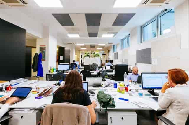 Open-plan office at Copernico Centrale: crowded coworking space for workshops and meetings.