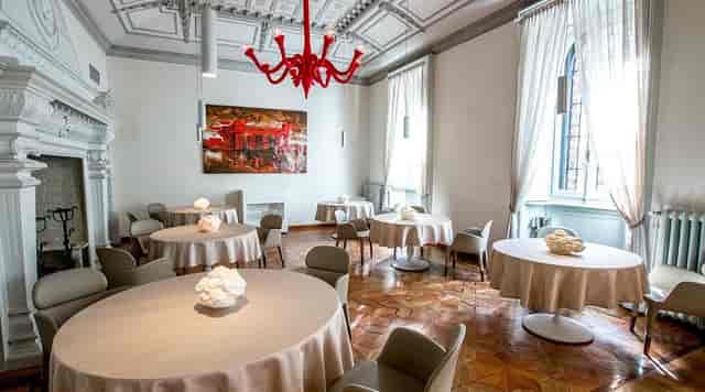 Dining Room at Contraste Milano with red chandelier for VIP lunches and board meetings.