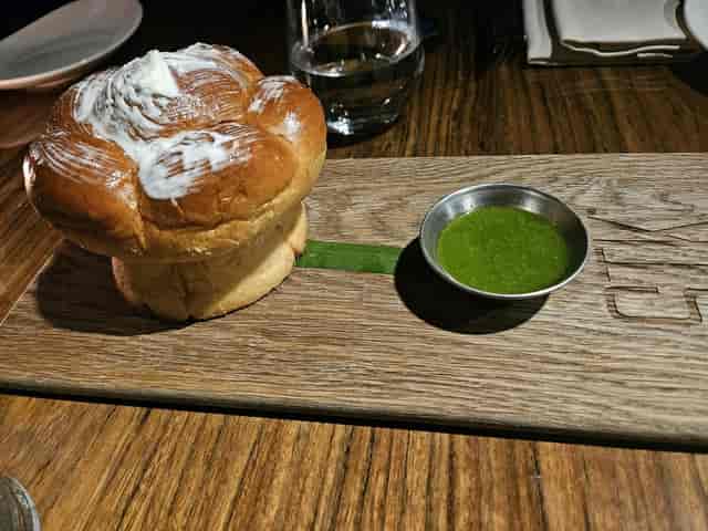 Artisanal bread service on rustic board for VIP dinner or corporate reception.