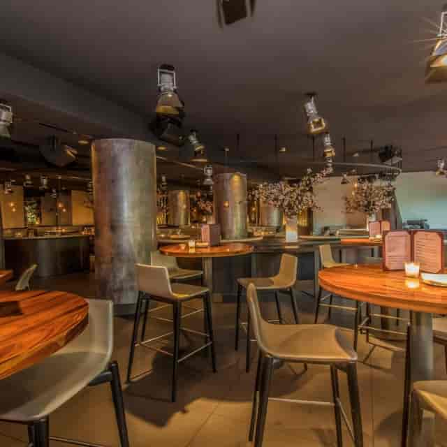 STK Milan cocktail bar with moody lighting for upscale evening receptions and networking events.