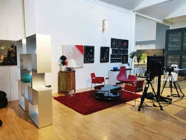 Studio breakout space with professional broadcast lighting for hybrid events and content production.