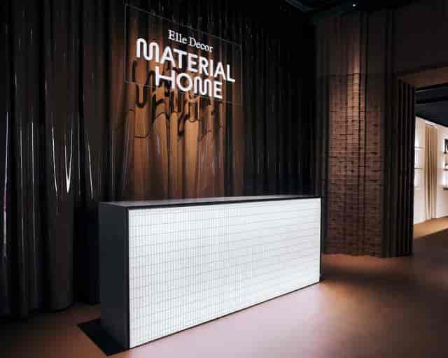 Minimalist registration desk with illuminated panel at Palazzo Bovara corporate event.