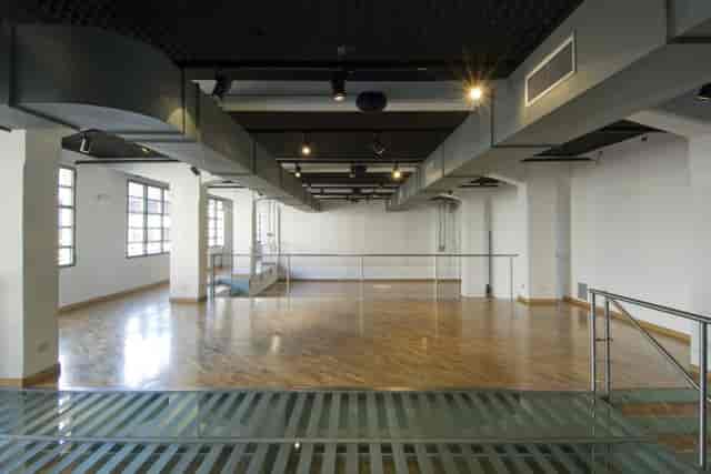 Industrial-chic event space with hardwood floors for gallery openings and pop-up activations.